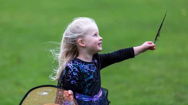 A young girl explores dressed in a Halloween outfit.